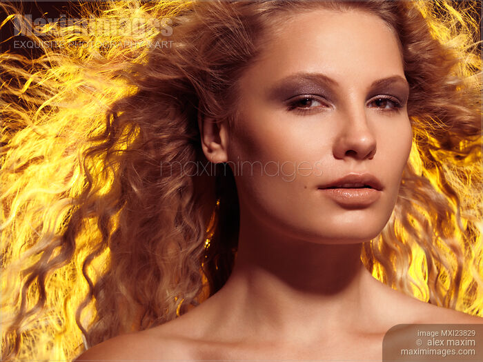 Beautiful Woman with Flying Golden Hair Stock photo of Beautiful Woman with Flying Golden Hair Buy commercial use license at MaximImages