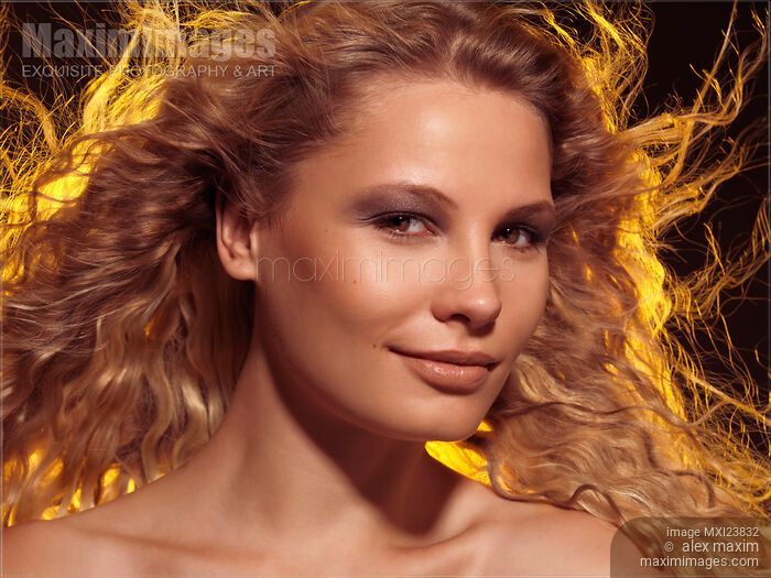 Beautiful Woman with Flying Golden Hair Stock photo of Beautiful Woman with Flying Golden Hair Buy commercial use license at MaximImages