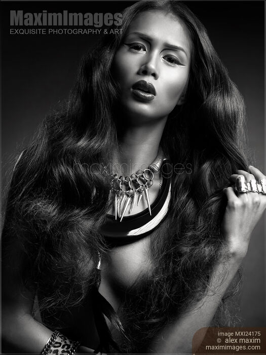 Stock photo of Beautiful woman with long hair wearing jewellery black and white Buy commercial use license at MaximImages