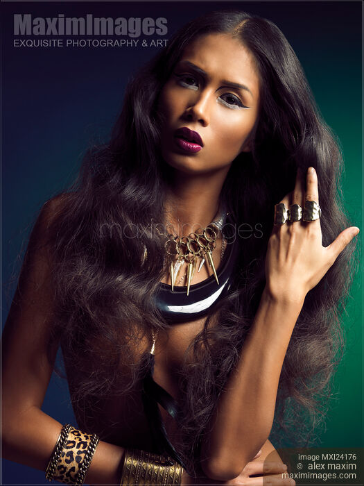 Beautiful woman with long hair wearing jewelry Stock photo of Beautiful woman with long hair wearing jewelry Buy commercial use license at MaximImages
