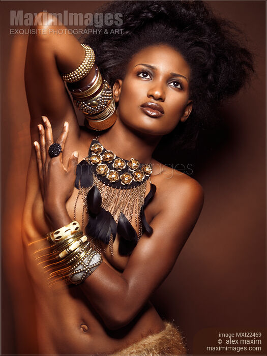 Beautiful Young African American Woman Wearing Jewelry on Brown Background Stock Image MXI22469 © Alex Maxim / MaximImages
