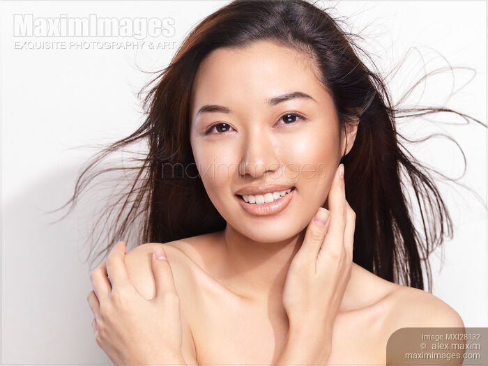 Beautiful young smiling asian woman with flying hair Stock photo of Beautiful young smiling asian woman with flying hair Buy commercial use license at MaximImages