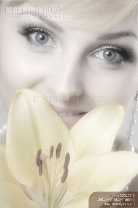 Beautiful Young Smiling Woman with Yellow Lily Stock photo of Beautiful Young Smiling Woman with Yellow Lily Buy commercial use license at MaximImages