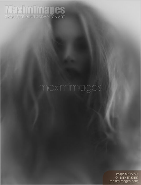 Beautiful young woman face behind hazy glass Stock photo of Beautiful young woman face behind hazy glass Buy commercial use license at MaximImages