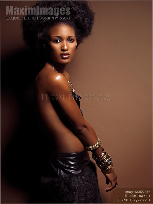 Stock photo of Beautiful Young Woman on Brown Background Buy commercial use license at MaximImages