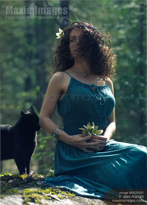 Beautiful young woman sitting in the nature wit ha black cat by her side Stock photo of Beautiful young woman sitting in the nature wit ha black cat by her side Buy commercial use license at MaximImages