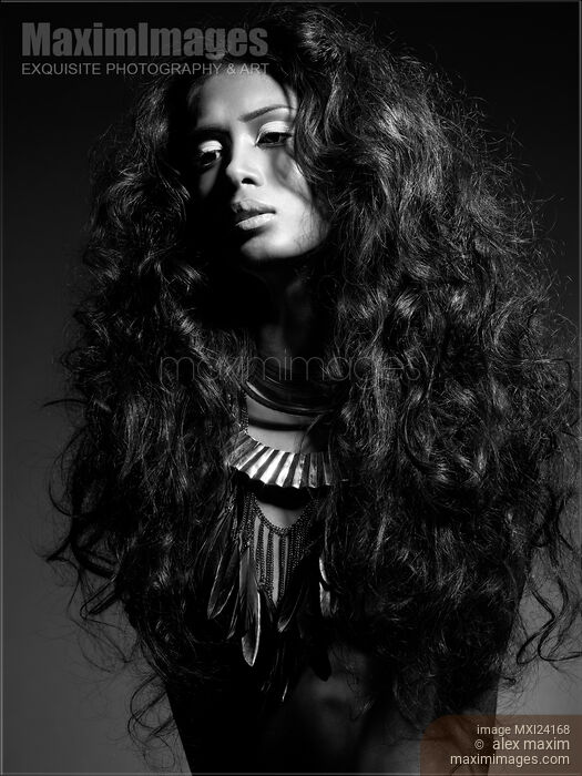 Stock photo of Beautiful young woman with long brown hair black and white Buy commercial use license at MaximImages