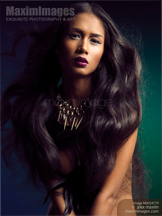Stock photo of Beautiful young woman with long flying hair Buy commercial use license at MaximImages