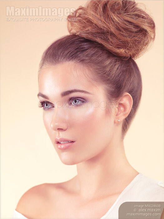 Beautiful young woman with natural look and updo Stock photo of Beautiful young woman with natural look and updo Buy commercial use license at MaximImages