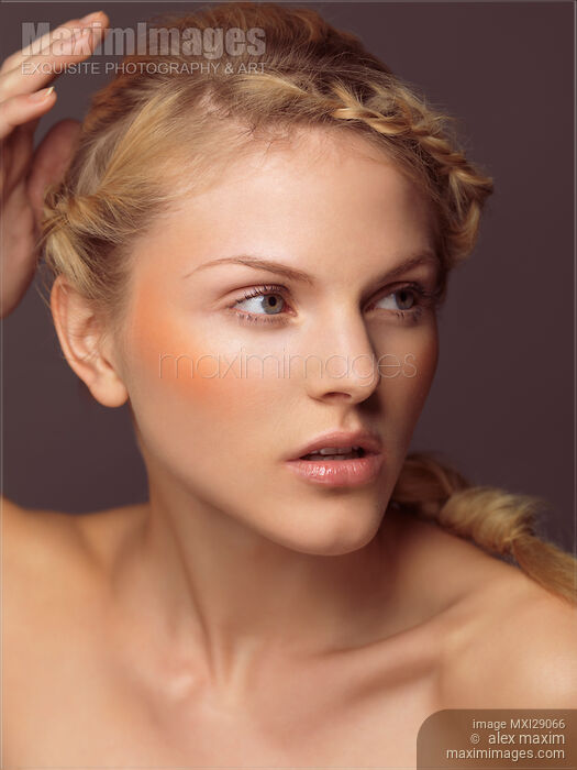 Stock photo of Beautiful Young Woman with Orange Blush Buy commercial use license at MaximImages