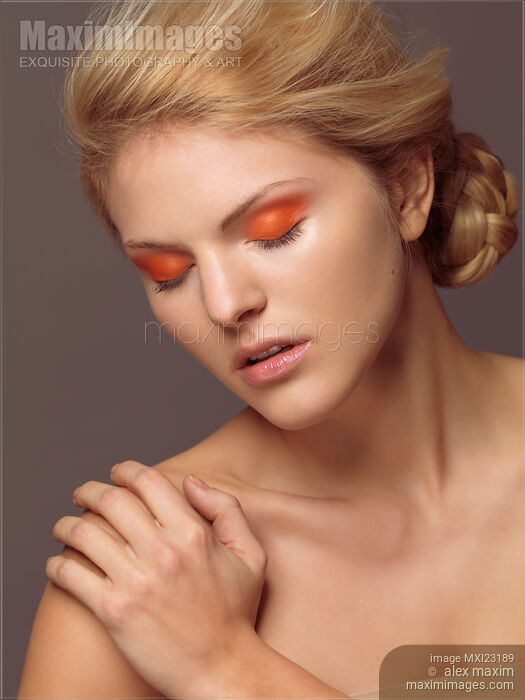 Beautiful Young Woman with Orange Eyeshadow Stock photo of Beautiful Young Woman with Orange Eyeshadow Buy commercial use license at MaximImages