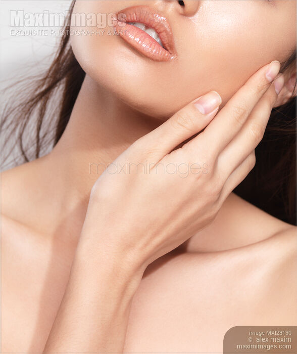 Beauty face closeup of young woman hand and lips Stock photo of Beauty face closeup of young woman hand and lips Buy commercial use license at MaximImages