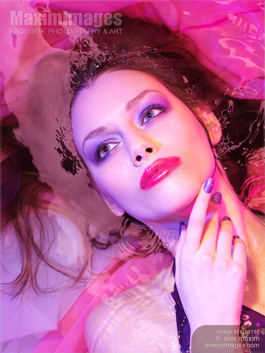 Beauty face portrait of woman lying in water with colorful makeup Stock photo of Beauty face portrait of woman lying in water with colorful makeup Buy commercial use license at MaximImages