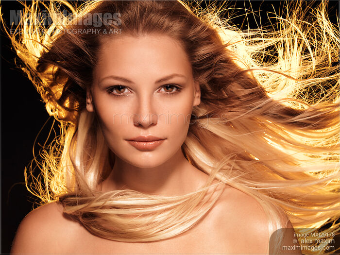 Beauty face portrait of woman with flying glowing blond hair Stock photo of Beauty face portrait of woman with flying glowing blond hair Buy commercial use license at MaximImages