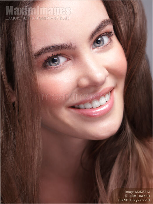 Beauty portrait of a smiling young woman closeup of face with big grey eyes and natural healthy soft look Stock photo of Beauty portrait of a smiling young woman closeup of face with big grey eyes and natural healthy soft look Buy commercial use license at MaximImages