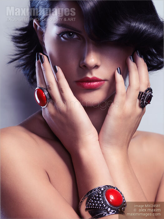 Stock photo of Beauty portrait of a woman wearing jewelry with red stones Buy commercial use license at MaximImages