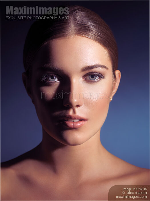 Stock photo of Beauty portrait of a young woman in dramatic light Buy commercial use license at MaximImages