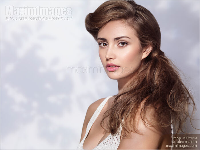 Beauty portrait of woman with beautiful long hair in a tree shadow Stock photo of Beauty portrait of woman with beautiful long hair in a tree shadow Buy commercial use license at MaximImages