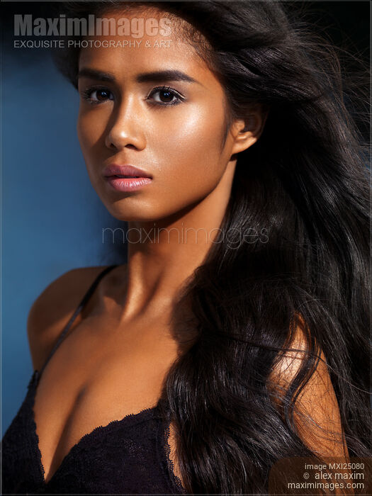 Beauty portrait of young exotic woman with dark skin and long black hair Stock photo of Beauty portrait of young exotic woman with dark skin and long black hair Buy commercial use license at MaximImages