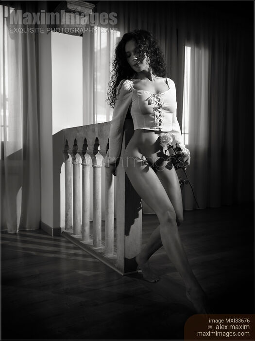 Black and white art nude portrait of a beautiful young woman dancing half-naked with a rose in dark room Stock photo of Black and white art nude portrait of a beautiful young woman dancing half-naked with a rose in dark room Buy commercial use license at MaximImages