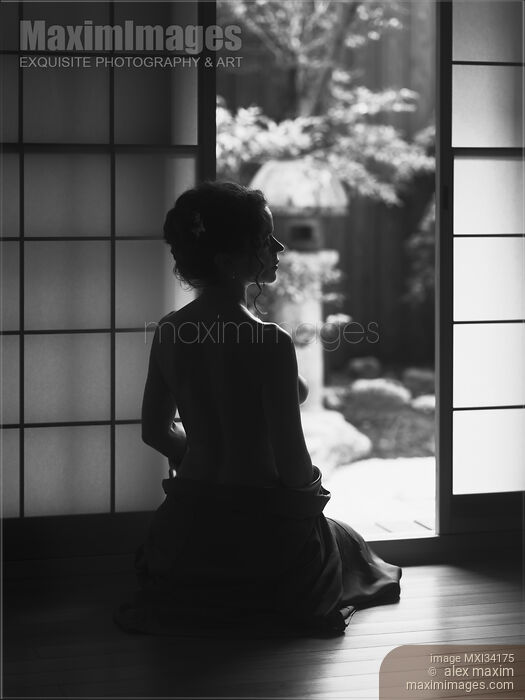 Black and white silhouette of a beautiful woman with naked back sitting by an open door of a Japanese house with Zen garden Stock photo of Black and white silhouette of a beautiful woman with naked back sitting by an open door of a Japanese house with Zen garden Buy commercial use license at MaximImages