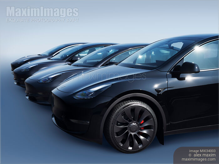Stock photo of Black Tesla Model Y and Tesla 3 electric cars in a row on blue background Buy commercial use license at MaximImages