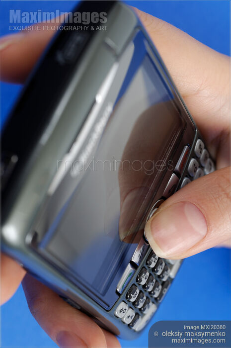 Stock photo of BlackBerry Smartphone in Hand Buy commercial use license at MaximImages