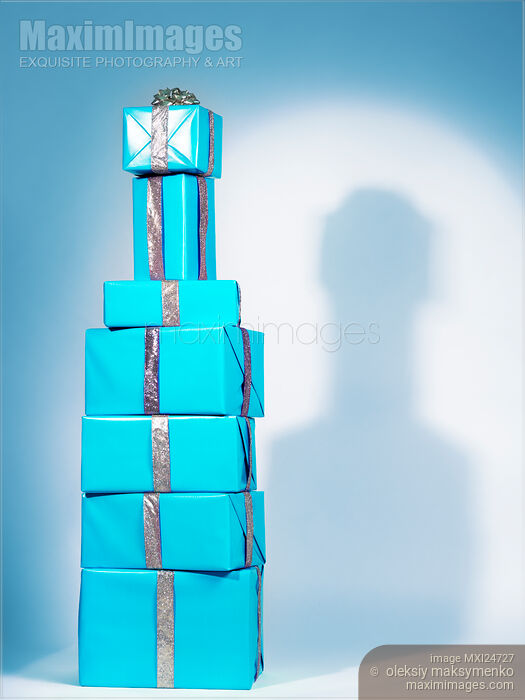 Blue gift wrapped presents stacked in shape of bottle Stock photo of Blue gift wrapped presents stacked in shape of bottle Buy commercial use license at MaximImages