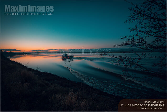 Stock photo of Boat in twilight tranquil nature scenery at Dundalk Bay Ireland Buy commercial use license at MaximImages