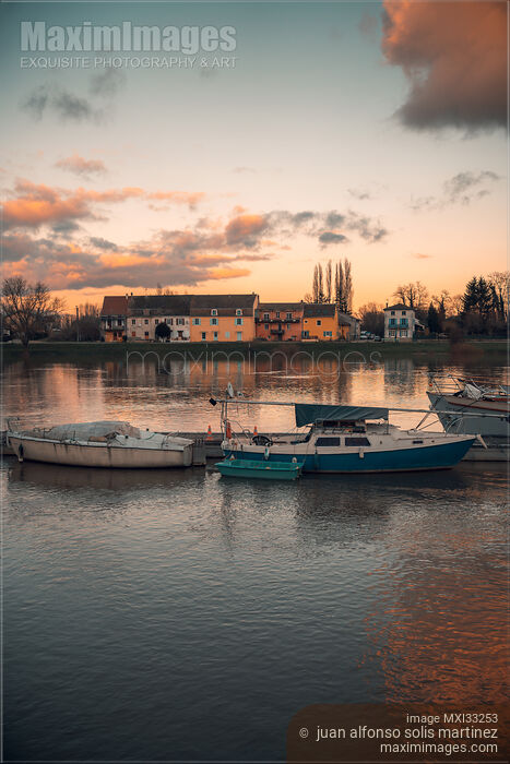 Boats in sunset scenery at Tournus town on the Saône River in France Stock photo of Boats in sunset scenery at Tournus town on the Saône River in France Buy commercial use license at MaximImages