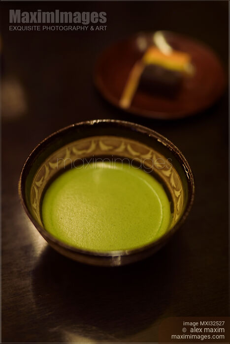 Bowl of Japanese Matcha ceremonial green tea and wagashi confection on a table Stock photo of Bowl of Japanese Matcha ceremonial green tea and wagashi confection on a table Buy commercial use license at MaximImages
