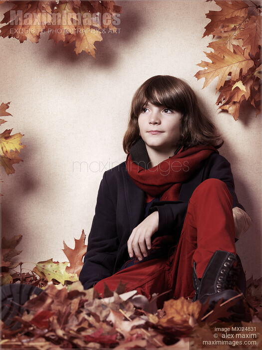 Boy sitting on autumn leaves artistic portrait Stock photo of Boy sitting on autumn leaves artistic portrait Buy commercial use license at MaximImages