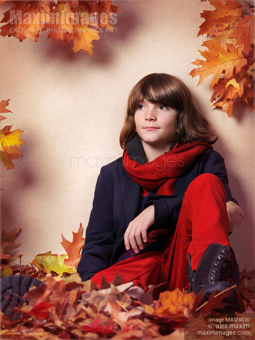 Boy sitting on autumn leaves fall fashion style Stock photo of Boy sitting on autumn leaves fall fashion style Buy commercial use license at MaximImages