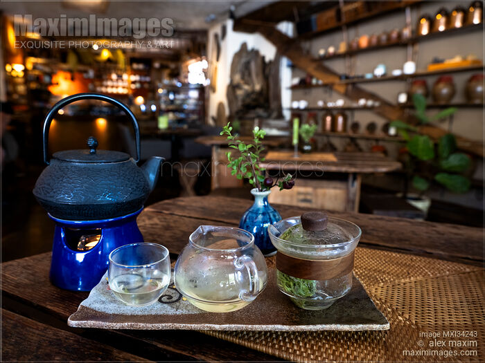 Stock photo of Brewing Oolong tea in a glass teapot on a wooden table of an old tea house Buy commercial use license at MaximImages