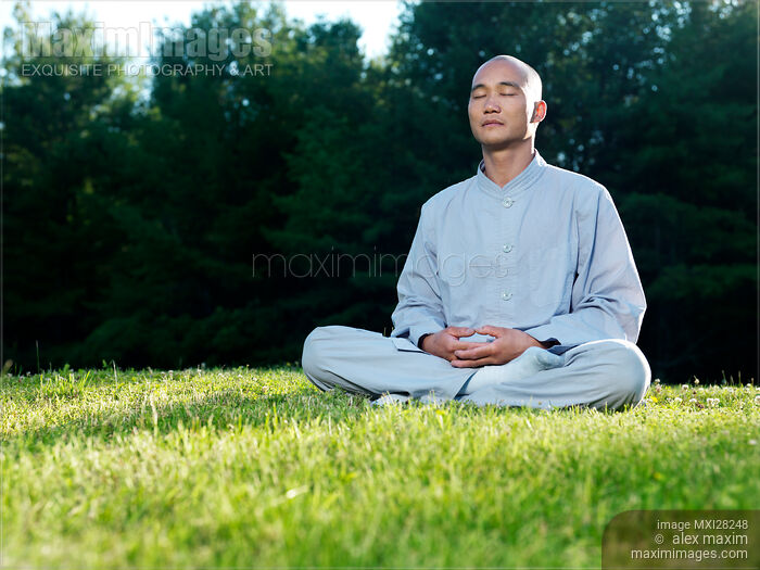 Stock photo of Buddhist monk meditating during sunrise Buy commercial use license at MaximImages