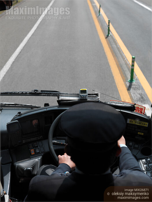 Stock photo of Bus driver at steering wheel Buy commercial use license at MaximImages