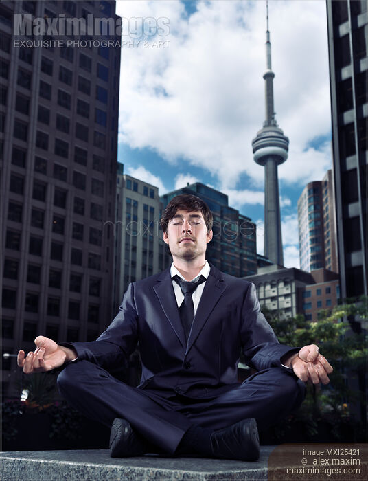 Stock photo of Businessman meditating in downtown Toronto Buy commercial use license at MaximImages