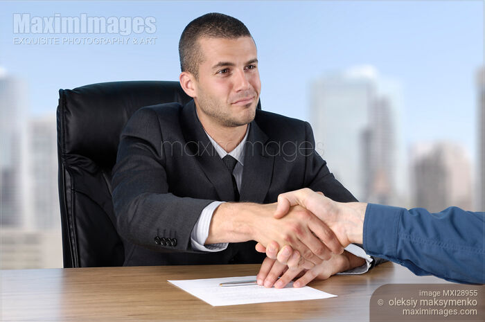 Stock photo of Businessman Shaking Hands with a Client Buy commercial use license at MaximImages