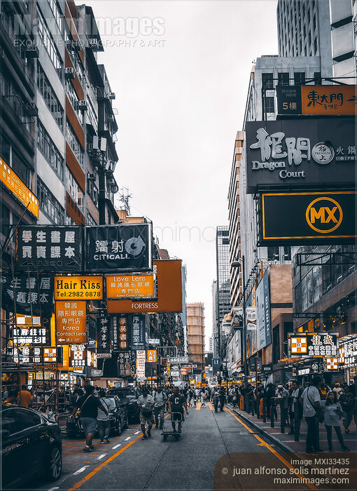 Stock photo of Busy streets of Hong Kong China full of people and shop signs Buy commercial use license at MaximImages