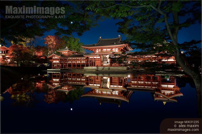 Stock photo of Byodo-in historic Japanese temple Phoenix Hall reflecting in the pond illuminated with lights at night Buy commercial use license at MaximImages
