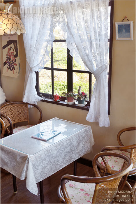 Stock photo of Cafe table near window Buy commercial use license at MaximImages