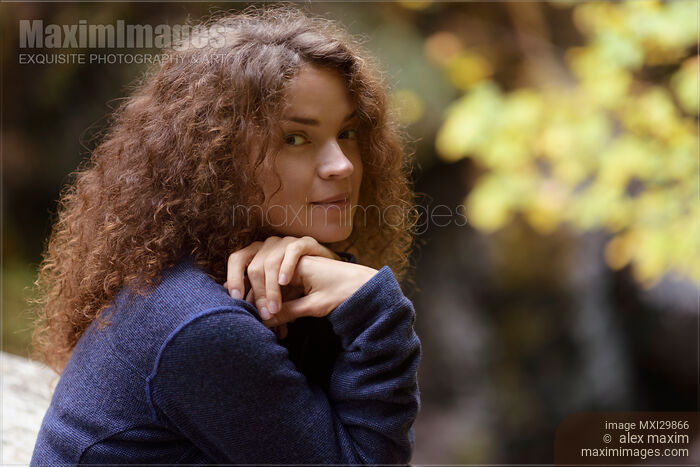 Candid natural portrait of young woman cute smiling expression on her face in the nature Stock photo of Candid natural portrait of young woman cute smiling expression on her face in the nature Buy commercial use license at MaximImages