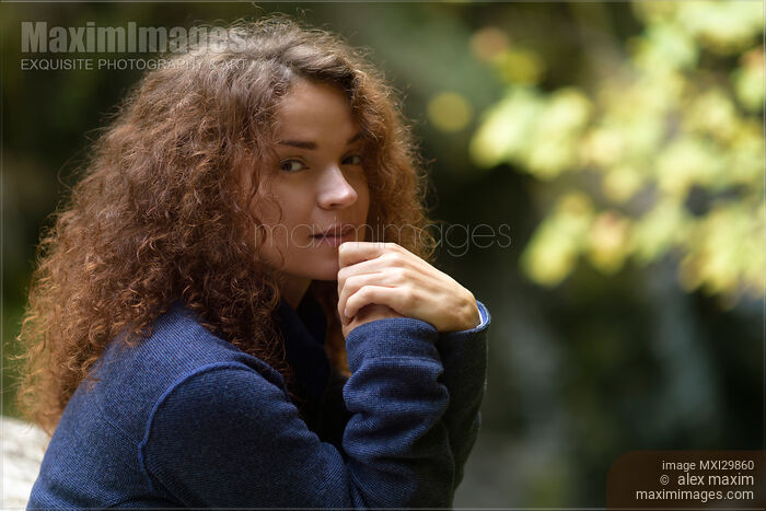 Candid natural portrait of young woman with tranquil thoughtul expression in the nature Stock photo of Candid natural portrait of young woman with tranquil thoughtul expression in the nature Buy commercial use license at MaximImages