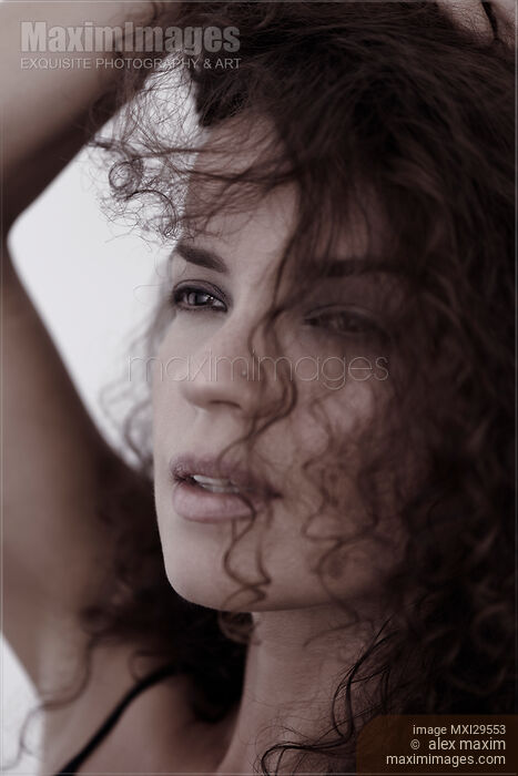 Candid upclose beauty portrait of a young woman face with expressive eyes gazing at the distance Stock photo of Candid upclose beauty portrait of a young woman face with expressive eyes gazing at the distance Buy commercial use license at MaximImages