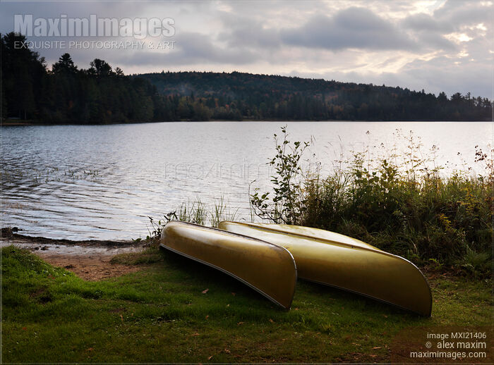 Stock photo of Canoe on a Shore of a Lake at Dawn Buy commercial use license at MaximImages