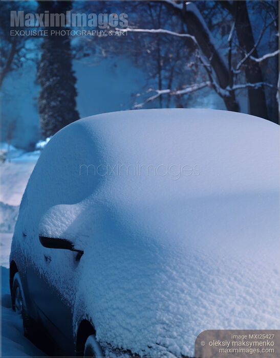 Stock photo of Car in snow storm covered with snow in winter Buy commercial use license at MaximImages