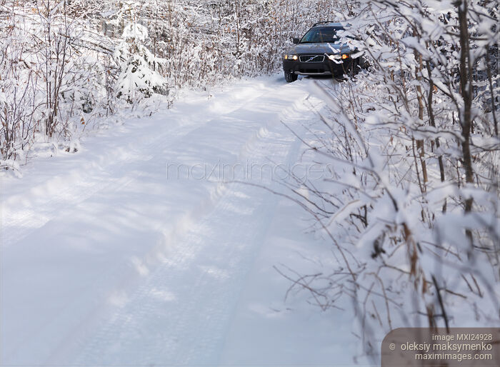 Stock photo of Car on snow covered country road Buy commercial use license at MaximImages