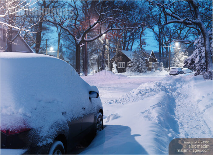 Stock photo of Cars covered with snow on city street in winter Buy commercial use license at MaximImages
