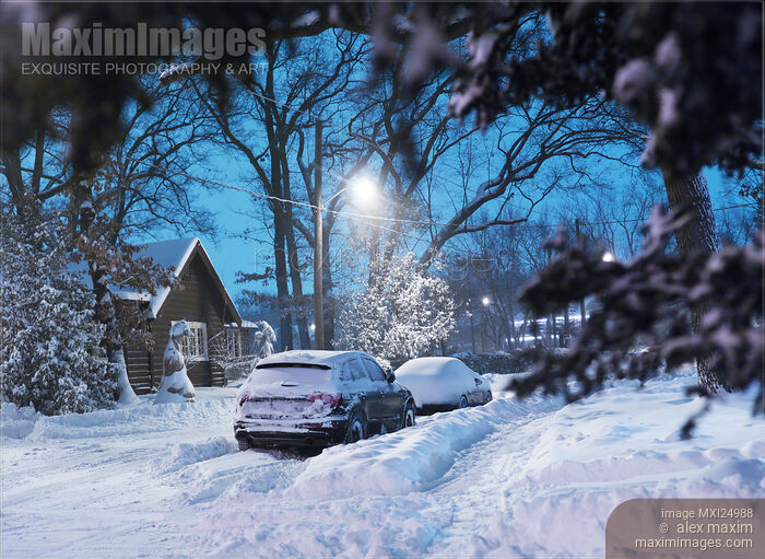 Stock photo of Cars on snow covered city street Buy commercial use license at MaximImages