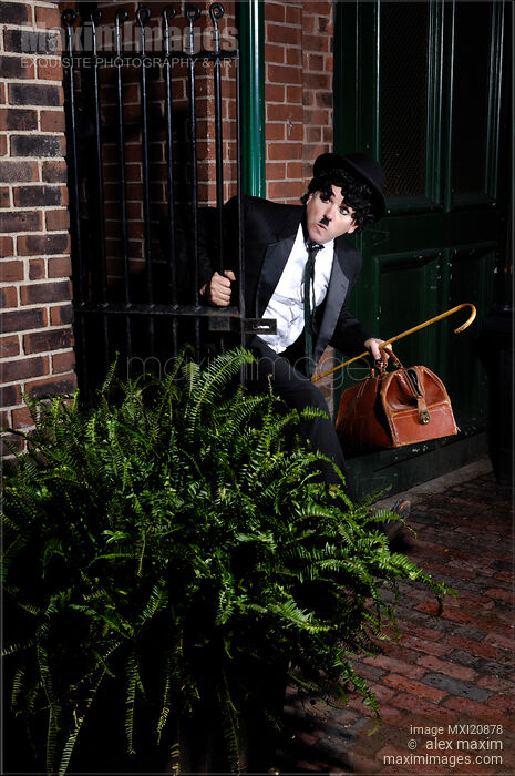 Stock photo of Charlie Chaplin Running Away Buy commercial use license at MaximImages